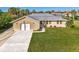 Single story home with attached garage and lush green lawn at 4646 Fallon Cir, Port Charlotte, FL 33948