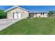 Tan single story home with a metal roof and attached garage at 4646 Fallon Cir, Port Charlotte, FL 33948