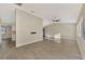 Spacious living room featuring tile floors and a ceiling fan at 4646 Fallon Cir, Port Charlotte, FL 33948