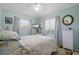 Light and airy bedroom with seashell bedding and white dresser at 345 Boundary Blvd # C, Rotonda West, FL 33947