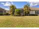Large backyard with lush lawn and screened patio at 1222 Collier Pl, Venice, FL 34293