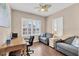 Bright home office features wood desk, comfortable seating, and wood flooring at 1222 Collier Pl, Venice, FL 34293