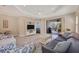 Bright living room with access to a screened patio, featuring comfortable seating and a large TV at 1222 Collier Pl, Venice, FL 34293