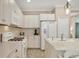 Modern kitchen with white cabinets and stainless steel appliances, offering ample counter space at 1222 Collier Pl, Venice, FL 34293
