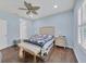 Light blue bedroom with queen bed, wooden flooring, and window shutters at 1222 Collier Pl, Venice, FL 34293