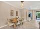 Bright dining room with a wooden table and four chairs, adjacent to the kitchen at 1222 Collier Pl, Venice, FL 34293