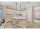 Modern kitchen with white cabinets, a large island, and stainless steel appliances at 1222 Collier Pl, Venice, FL 34293