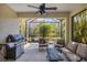 Screened lanai with outdoor seating and grill at 1222 Collier Pl, Venice, FL 34293