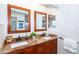 Double vanity bathroom with granite countertops and wood cabinets at 172 Southampton Pl # 346, Venice, FL 34293