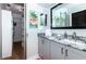 Bathroom with gray vanity, granite countertop, and walk-in closet at 172 Southampton Pl # 346, Venice, FL 34293