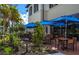 Restaurant patio with blue umbrellas and tables at 172 Southampton Pl # 346, Venice, FL 34293