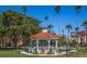 White gazebo with red tile roof in a park at 172 Southampton Pl # 346, Venice, FL 34293