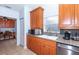 Efficient kitchen featuring ample cabinetry, granite countertops, and a breakfast bar at 172 Southampton Pl # 346, Venice, FL 34293