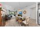 Open dining room with glass-top table, chandelier, and view of the living room and pool at 9888 Bright Water Dr, Englewood, FL 34223