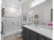 Clean bathroom with a walk-in shower and modern vanity at 9888 Bright Water Dr, Englewood, FL 34223