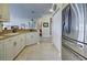 Bright kitchen with stainless steel refrigerator and white cabinetry at 1704 Triano Cir # 1704, Venice, FL 34292