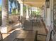 Covered patio with multiple tables and chairs, overlooking the pool at 1704 Triano Cir # 1704, Venice, FL 34292