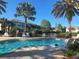 Inviting community pool with lounge chairs and lush landscaping at 1704 Triano Cir # 1704, Venice, FL 34292