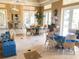 Bright and airy community room with multiple seating areas and large windows at 1704 Triano Cir # 1704, Venice, FL 34292
