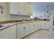 Well-equipped kitchen featuring white cabinets and granite countertops at 1704 Triano Cir # 1704, Venice, FL 34292