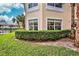 Building exterior showcasing manicured hedges and lake views at 1704 Triano Cir # 1704, Venice, FL 34292