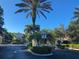 Community entrance with palm trees and a clear directional sign at 1704 Triano Cir # 1704, Venice, FL 34292