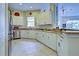 Well-equipped kitchen with white cabinets and granite countertops at 1704 Triano Cir # 1704, Venice, FL 34292