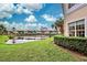 Lovely backyard view of a lake and lush landscaping at 1704 Triano Cir # 1704, Venice, FL 34292