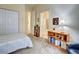 Well-lit bedroom with a bed, bookcase and access to bathroom at 1704 Triano Cir # 1704, Venice, FL 34292