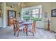 Bright dining room featuring a wooden table and large windows at 1704 Triano Cir # 1704, Venice, FL 34292