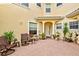 Private courtyard with brick paving, potted plants, and comfy seating at 1704 Triano Cir # 1704, Venice, FL 34292