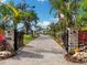Long brick driveway leads to this luxury home, surrounded by lush landscaping and mature trees at 1109 Bayshore Rd, Nokomis, FL 34275