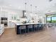 Bright, modern kitchen with white cabinetry, stainless steel appliances, and a large island with bar seating at 1109 Bayshore Rd, Nokomis, FL 34275