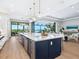 Spacious kitchen with a large center island and stainless steel appliances overlooking the living area at 1109 Bayshore Rd, Nokomis, FL 34275