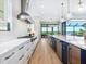 Well-lit kitchen with white cabinetry, modern appliances, and views of the outdoor dining area at 1109 Bayshore Rd, Nokomis, FL 34275