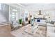 Open-concept living area with modern furnishings, staircase, and seamless flow to the kitchen and dining spaces at 1109 Bayshore Rd, Nokomis, FL 34275