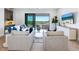 A comfortable living room featuring a light color scheme, wood floors and a balcony at 1109 Bayshore Rd, Nokomis, FL 34275