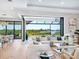 Open-concept living area with sliding glass doors to outdoor pool and waterway views at 1109 Bayshore Rd, Nokomis, FL 34275