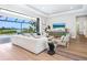 Bright living room with modern furnishings, hardwood floors, and stunning water views at 1109 Bayshore Rd, Nokomis, FL 34275