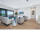 A comfortable living room featuring a light color scheme, wood floors and a balcony at 1109 Bayshore Rd, Nokomis, FL 34275