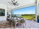 Covered outdoor dining area with a large table and seating, overlooking a tranquil water view at 1109 Bayshore Rd, Nokomis, FL 34275
