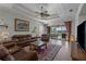 Spacious living room with coffered ceilings, leather furniture and sliding glass doors to outdoor patio at 11149 Staveley Ct, Venice, FL 34293