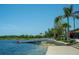Wooden dock on a calm lake with a metal footbridge at 13848 Rinuccio St, Venice, FL 34293