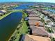 Aerial view of a lakefront home with lush landscaping at 13848 Rinuccio St, Venice, FL 34293