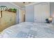 Charming bedroom featuring a light blue color scheme, and a comfortable bed with a patchwork quilt at 13848 Rinuccio St, Venice, FL 34293