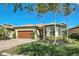 Single-story home with brown garage door and palm trees at 13848 Rinuccio St, Venice, FL 34293