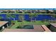 Aerial view of a waterfront home community with lush landscaping and canal views at 13848 Rinuccio St, Venice, FL 34293