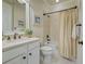 Simple and elegant bathroom with a tub/shower combo, neutral color scheme, and a white vanity at 13848 Rinuccio St, Venice, FL 34293