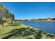 Scenic view of a tranquil lake with lush landscaping and residential homes at 13848 Rinuccio St, Venice, FL 34293