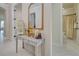 Bright entryway with console table, mirror, and view of bathroom at 13848 Rinuccio St, Venice, FL 34293
